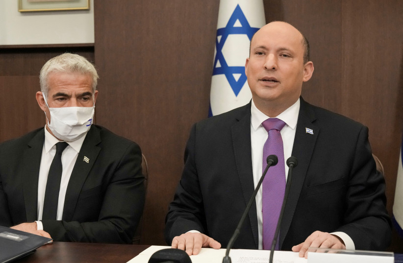  Israeli Prime Minister Naftali Bennett chairs the weekly cabinet meeting with Israeli Foreign Minister Yair Lapid in Jerusalem, February 20, 2022. (photo credit: Tsafrir Abayov/Pool via REUTERS)
