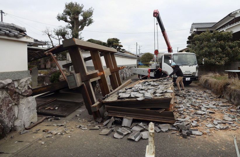  A collapsed gate to the residential house caused by an earthquake is seen in Oita, southern Japan, January 22, 2022 (photo credit: KYODO/VIA REUTERS)