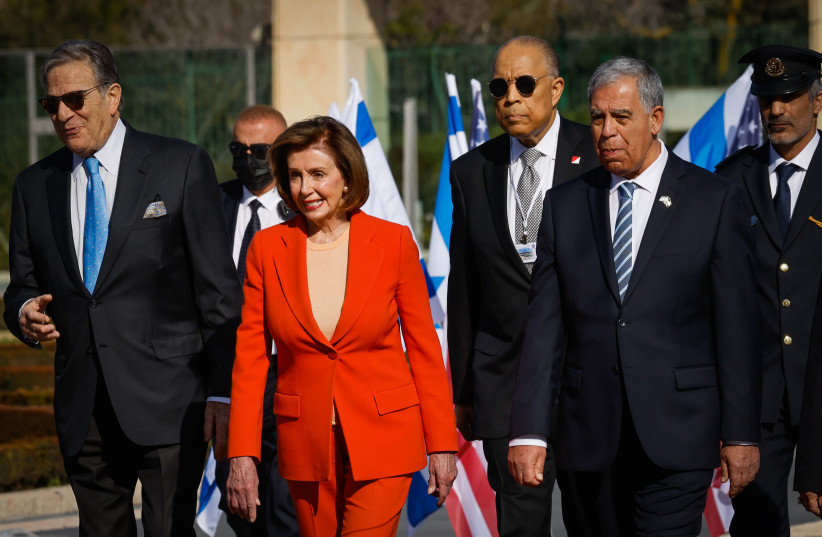  US Speaker of the House Nancy Pelosi walks with Knesset Speaker Mickey Levy as she arrives for an official visit at the Knesset, the Israeli Parliament in Jerusalem, February 16, 2022.  (credit: OLIVIER FITOUSSI/FLASH90)