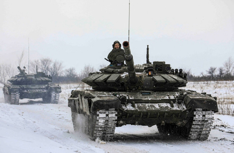  Russian servicemen drive tanks during military exercises in the Leningrad Region, Russia, in this handout picture released February 14, 2022. (photo credit: Russian Defence Ministry/Handout via REUTERS)