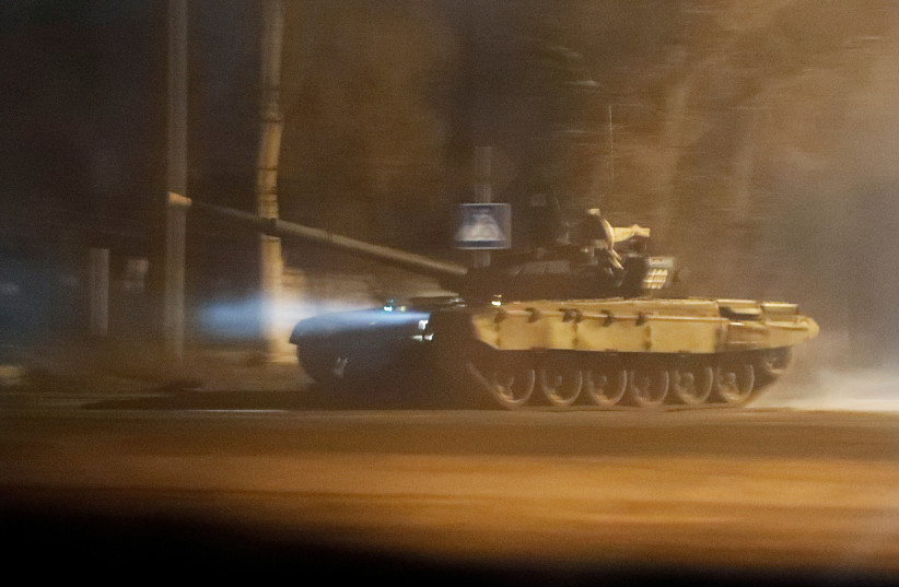  A tank drives along a street after Russian President Vladimir Putin ordered the deployment of Russian troops to two breakaway regions in eastern Ukraine following the recognition of their independence, in the separatist-controlled city of Donetsk, Ukraine (photo credit: REUTERS/ALEXANDER ERMOCHENKO)
