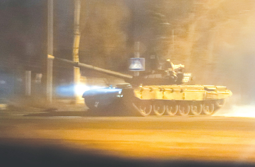 A TANK drives along a street in Donetsk yesterday, after Russian President Vladimir Putin ordered the deployment of Russian troops to two breakaway regions in eastern Ukraine, following the recognition of their independence.  (photo credit: REUTERS/ALEXANDER ERMOCHENKO)