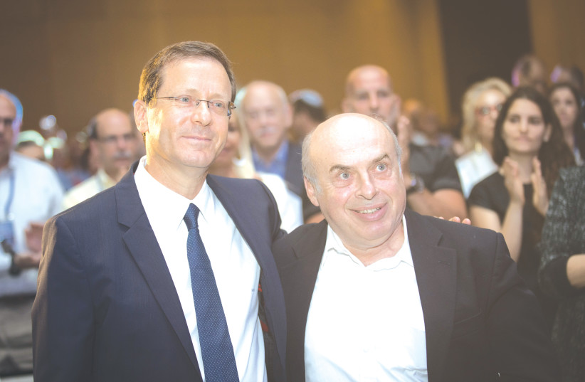  PRESIDENT ISAAC HERZOG, then as incoming Jewish Agency chairman, stands with then-outgoing Agency leader Natan Sharansky at the board of governors conference in Jerusalem in 2018. (photo credit: HADAS PARUSH/FLASH90)