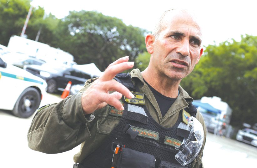  COL. GOLAN VACH, commander of the IDF National Rescue unit, stands near the partially collapsed residential building in Surfside, Florida, during search and rescue operations last year.  (photo credit: MARCO BELLO/REUTERS)