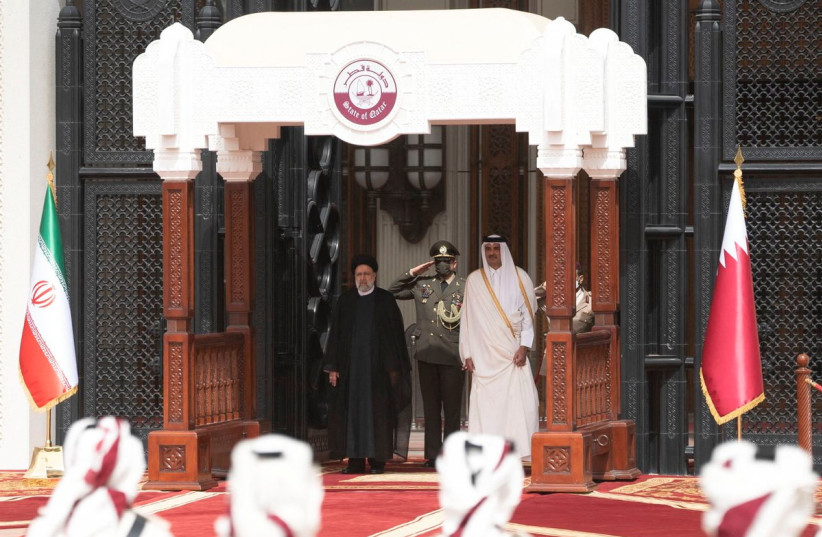 Qatar's Emir Sheikh Tamim bin Hamad Al-Thani and Iran's President Ebrahim Raisi stand during a welcome ceremony in Doha, Qatar, February 21, 2022. (credit: QATAR NEWS AGENCY/HANDOUT VIA REUTERS)