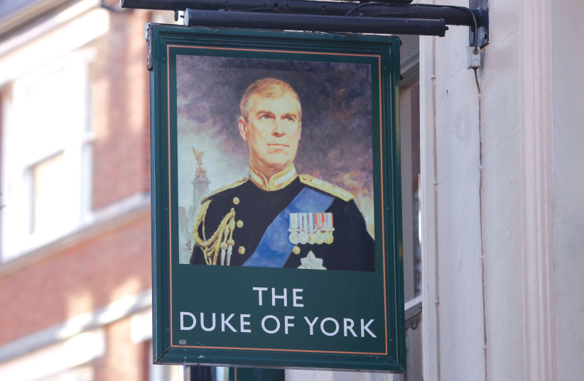  A PORTRAIT of Britain’s Prince Andrew is seen on display on a sign outside the Duke of York public house in London last month. (photo credit: JOHN SIBLEY/REUTERS)