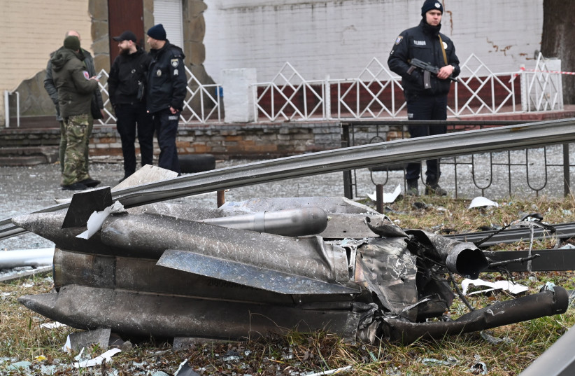 Police and security personnel inspect the remains of a shell landed in a street in Kyiv on February 24, 2022.  (credit: SERGEI SUPINSKY/AFP via Getty Images)
