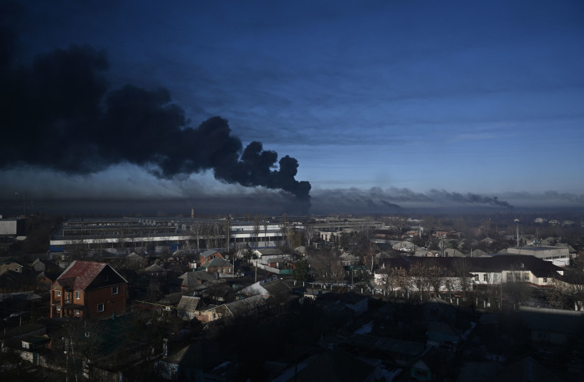  Black smoke rises from a military airport in Chuguyev near Kharkiv on February 24, 2022. (photo credit: ARIS MESSINIS/AFP via Getty Images)