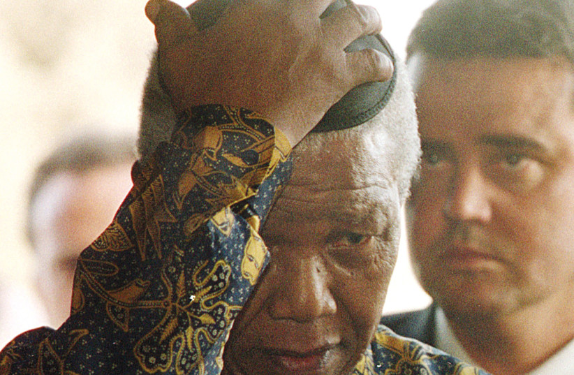  Nelson Mandela dons a kippa during his visit to Yad Vashem in 1999 (photo credit: REUTERS)