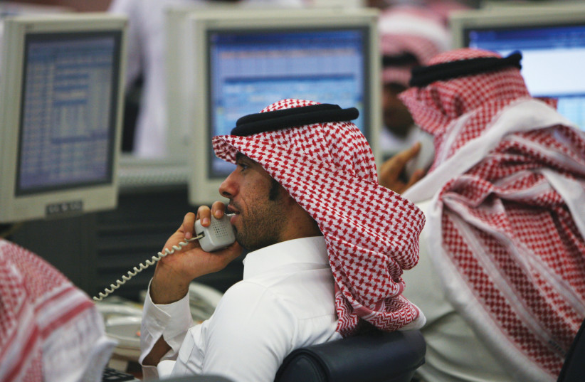  TRADERS AT work in the Saudi Investment Bank in Riyadh. (photo credit: REUTERS/FAHAD SHADEED)