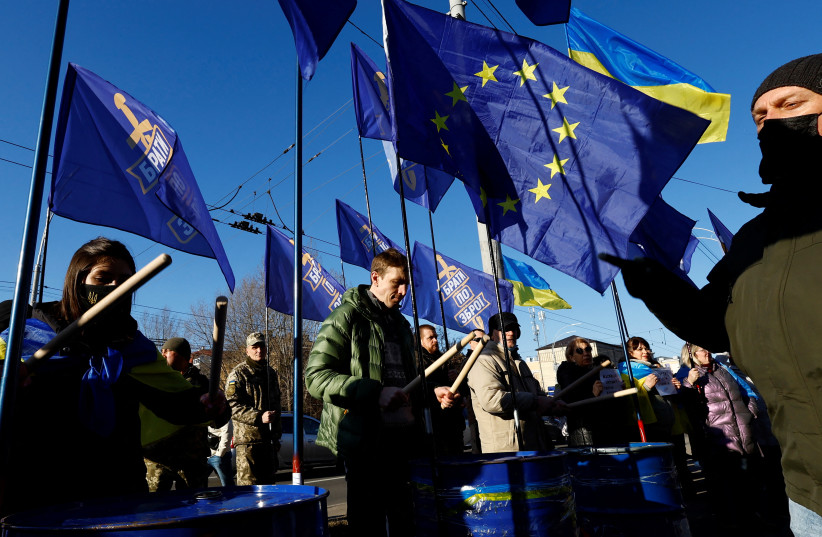  Ukrainians shout slogans, wave Ukrainian national and EU flags, hold banners as they protest outside Russian embassy after Moscow's decision to formally recognise two Russian-backed regions of eastern Ukraine as independent in central Kyiv, Ukraine, February 22, 2022 (credit: REUTERS/UMIT BEKTAS)