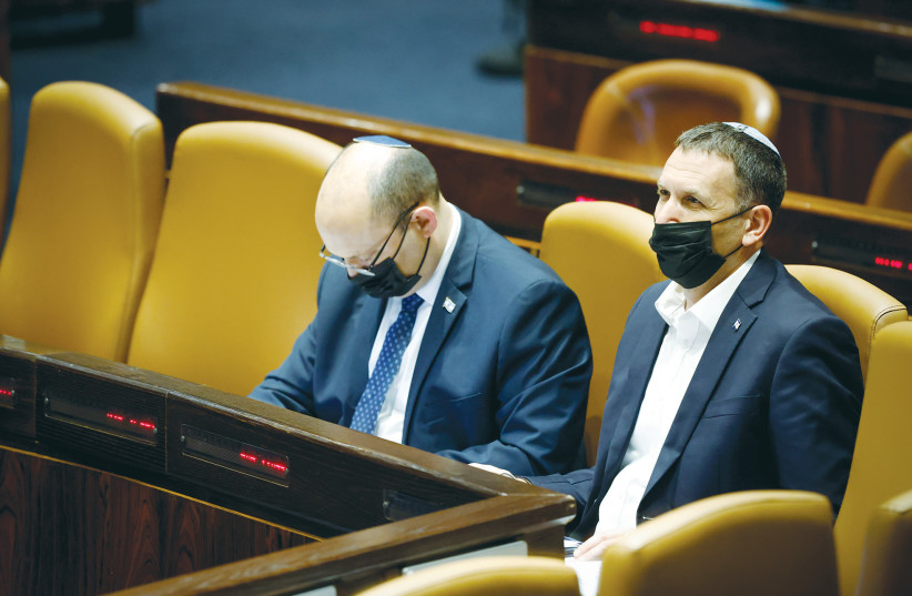  RELIGIOUS SERVICES Minister Matan Kahana sits next to Prime Minister Naftali Bennett during a session in the Knesset plenum earlier this month. (photo credit: OLIVIER FITOUSSI/FLASH90)