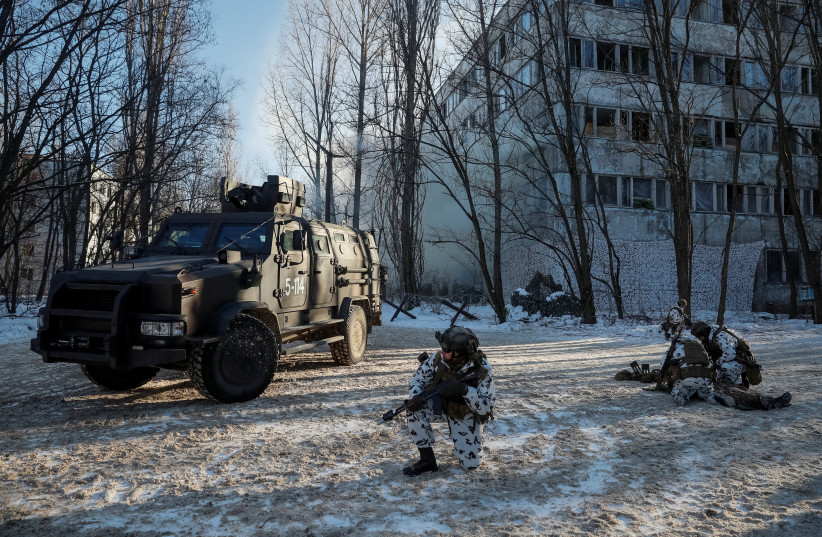  Service members take part in tactical exercises, which are conducted by the Ukrainian National Guard, Armed Forces, special operations units and simulate a crisis situation in an urban settlement, in the abandoned city of Pripyat near the Chernobyl Nuclear Power Plant, Ukraine February 4, 2022 (photo credit: REUTERS/GLEB GARANICH)