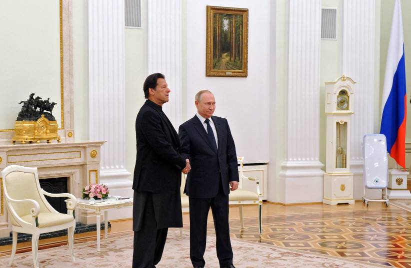  Russian President Vladimir Putin shakes hands with Pakistan's Prime Minister Imran Khan during a meeting in Moscow, Russia February 24, 2022. (photo credit: MIKHAIL KLIMENTYEV/SPUTNIK/REUTERS)
