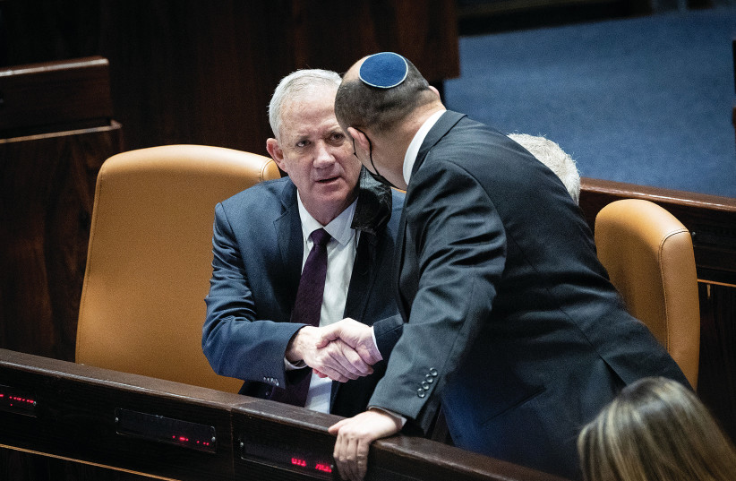  PRIME MINISTER Naftali Bennett shakes hands with Defense Minister Benny Gantz last month in the Knesset. (credit: YONATAN SINDEL/FLASH90)