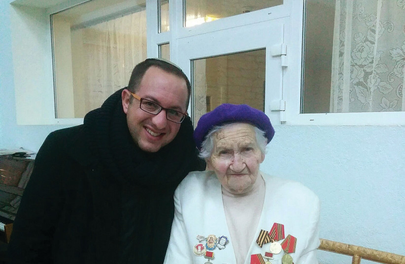  THE WRITER with an elderly Ukrainian Jew in Dnipro in 2015. (credit: Zvika Klein)