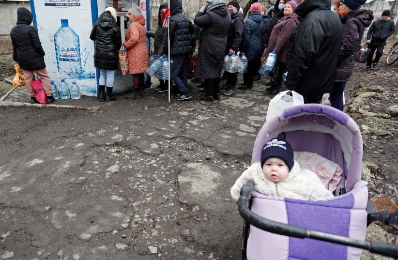  People stand in line to buy drinking water in the separatist-controlled city of Donetsk, Ukraine February 26, 2022.  (photo credit: REUTERS/ALEXANDER ERMOCHENKO)
