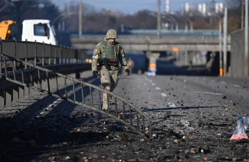  An Ukrainian soldier walks through debris on the west side of the Ukrainian capital of Kyiv on February 26, 2022.  (photo credit: DANIEL LEAL/AFP via Getty Images)