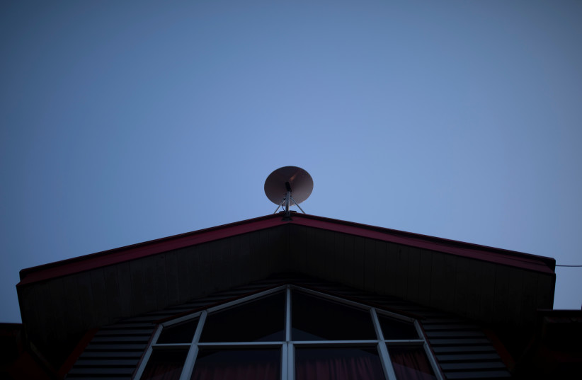  The Starlink antenna is seen on the roof of the John F Kennedy School located in the village of Sotomo, outside the town of Cochamo, Los Lagos region, Chile, August 7, 2021 (credit: Pablo Sanhueza/Reuters)