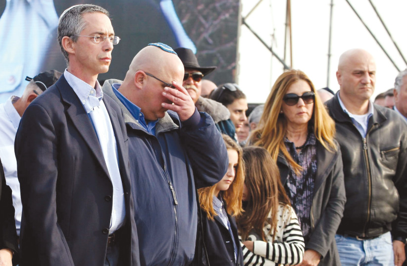  GILAD (left) and Omri (second from left) Sharon attend their father’s funeral at the former prime minister’s ranch in the Negev, January 2014. (photo credit: EDI ISRAEL/FLASH90)