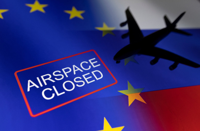  A model airplane is displayed on EU and Russian flags with words "Airspace closed" in this illustration taken, February 27, 2022. (photo credit: REUTERS/DADO RUVIC/ILLUSTRATION)