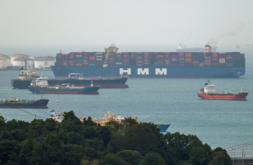  A container vessel is seen leaving the Pasir Panjang terminal port in Singapore on January 17, 2022.  (photo credit: ROSLAN RAHMAN/AFP via Getty Images)
