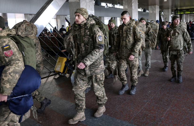  Ukrainian soldiers walk at Kyiv central train station, Ukraine, February 25, 2022 (photo credit: UMIT BEKTAS/REUTERS)