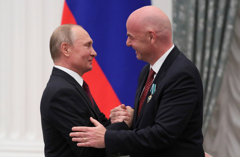  Russian President Vladimir Putin shakes hands with FIFA President Gianni Infantino after decorating him with the Order of Friendship during an awarding ceremony at the Kremlin in Moscow, Russia May 23, 2019 (photo credit: REUTERS/EVGENIA NOVOZHENINA)