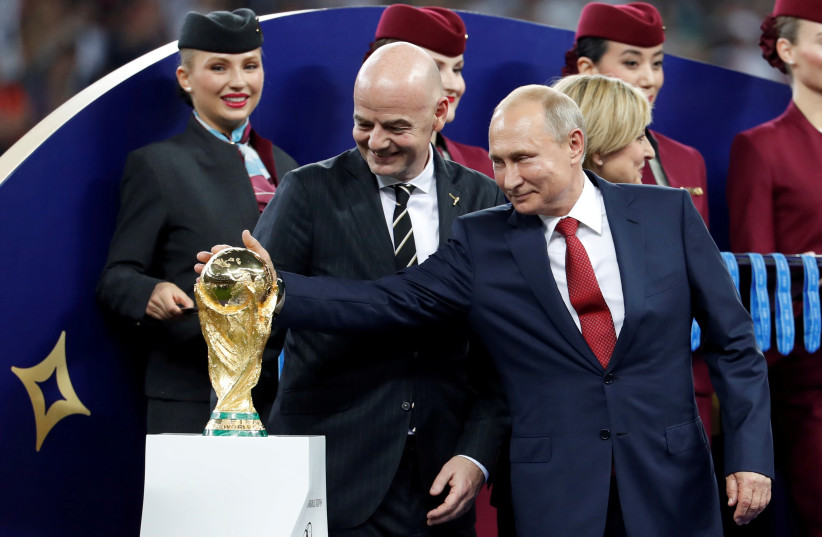  FIFA president Gianni Infantino and President of Russia Vladimir Putin with the World Cup trophy (credit: REUTERS/DAMIR SAGOLJ/FILE PHOTO)