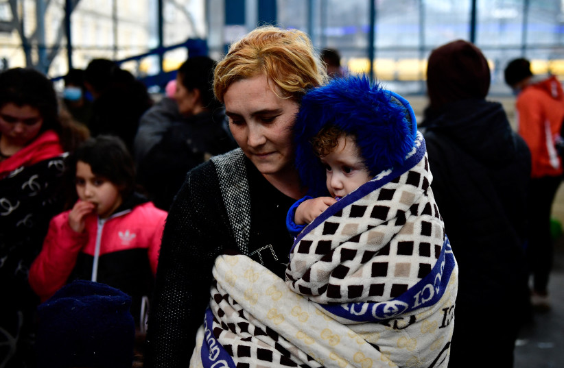  Mother fleeing from Ukraine stands with her son at Nyugati station, after Russia's invasion of Ukraine, in Budapest, Hungary, February 28, 2022 (photo credit: REUTERS/MARTON MONUS)