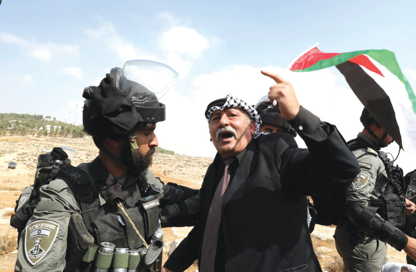  A PALESTINIAN protests against cutting the water supply to Palestinian villages in the South Hebron Hills, in October (photo credit: WISAM HASHLAMOUN/FLASH90)