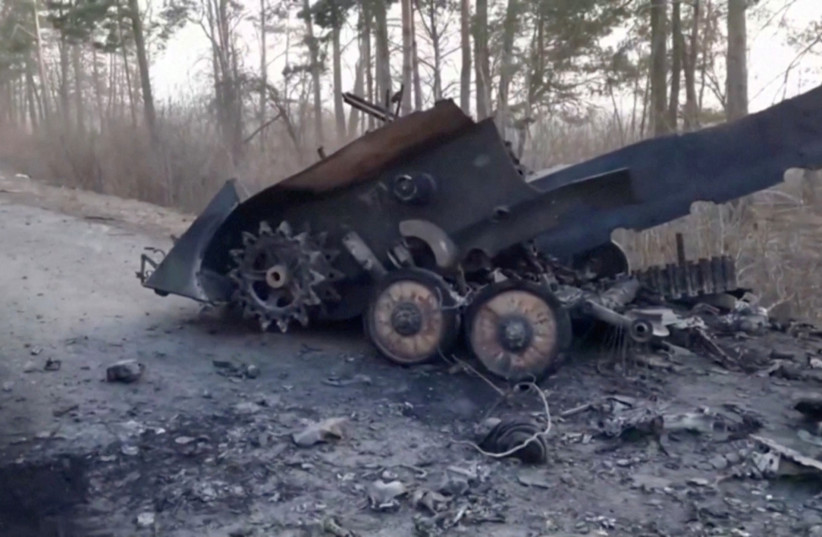  Destroyed military hardware is seen on a road during Russia's invasion of Ukraine at an unidentified location in this still image taken from video released by the Russian Ministry of Defence February 28, 2022. The ministry did not specify the place or time when the video was filmed.  (credit: Russian Ministry of Defence/via Reuters TV/Handout via REUTERS)