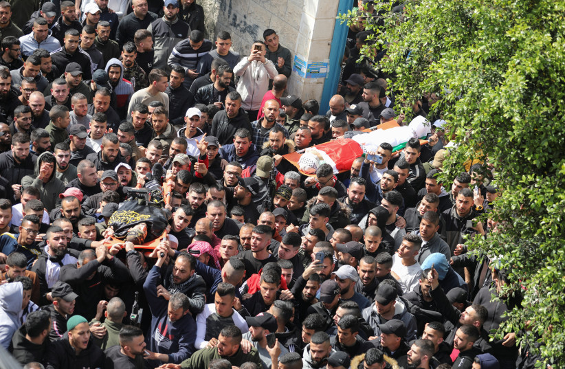  Mourners carry bodies of two Palestinian Islamic Jihad gunmen, who were killed by Israeli forces, during a funeral in Jenin in the Israeli-occupied West Bank March 1, 2022.  (credit: RANEEN SAWAFTA/ REUTERS)