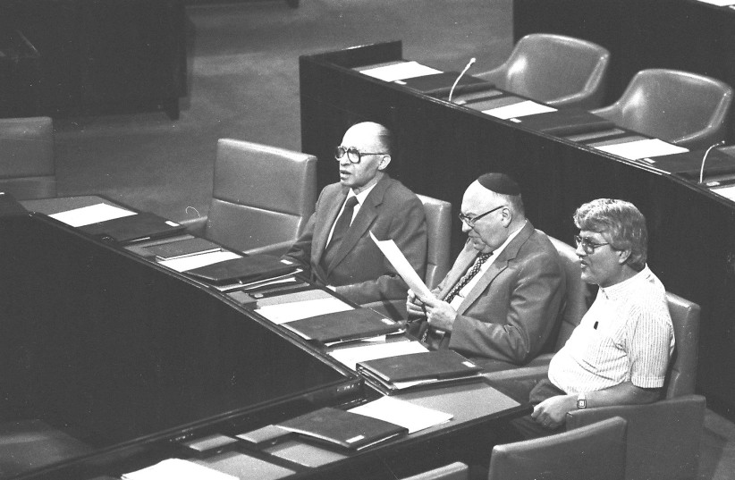  THEN-PRIME MINISTER Menachem Begin (left) sits at the head of the government table in the Knesset plenum in 1983. (photo credit: YOSSI ZAMIR/FLASH90)