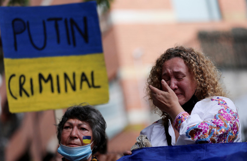 A woman reacts as she attends an anti-war protest outside the Russian Embassy, following Russia's invasion of Ukraine, in Bogota, Colombia March 1, 2022 (photo credit: LUISA GONZALEZ/REUTERS)