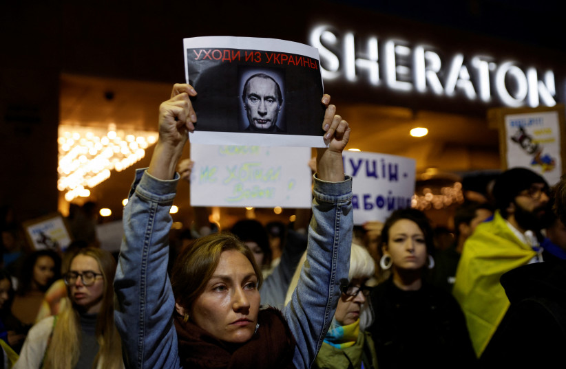  A woman holds up a sign at a rally in support of Ukraine after Russian President Vladimir Putin authorised a military operation in eastern Ukraine, outside the Russian Embassy in Tel Aviv, Israel, February 24, 2022.  (photo credit: REUTERS/AMIR COHEN)