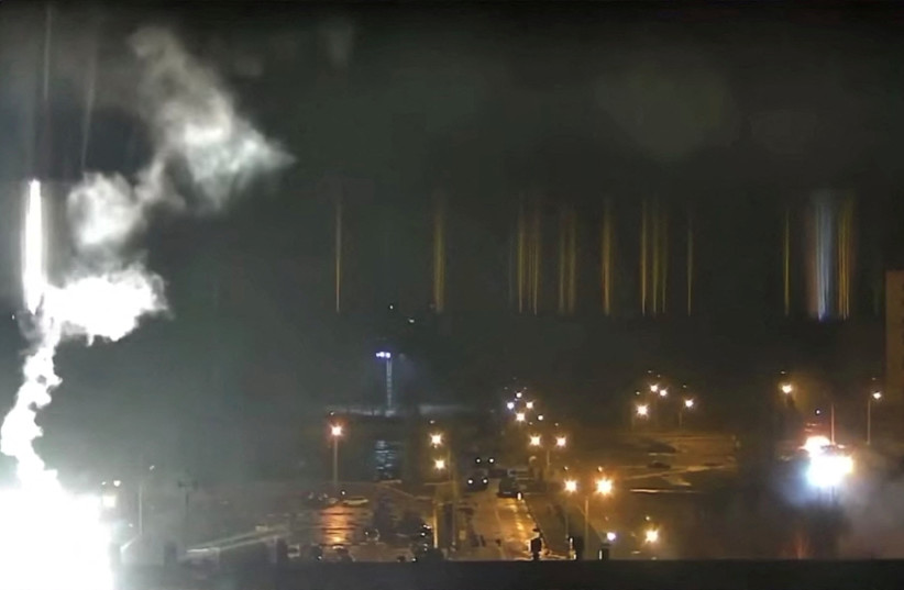 Surveillance camera footage shows a flare landing at the Zaporizhzhia nuclear power plant during shelling in Enerhodar, Zaporizhia Oblast, Ukraine March 4, 2022, in this screengrab from a video obtained from social media. (photo credit: ZAPORIZHZHYA NPP VIA YOUTUBE/VIA REUTERS)