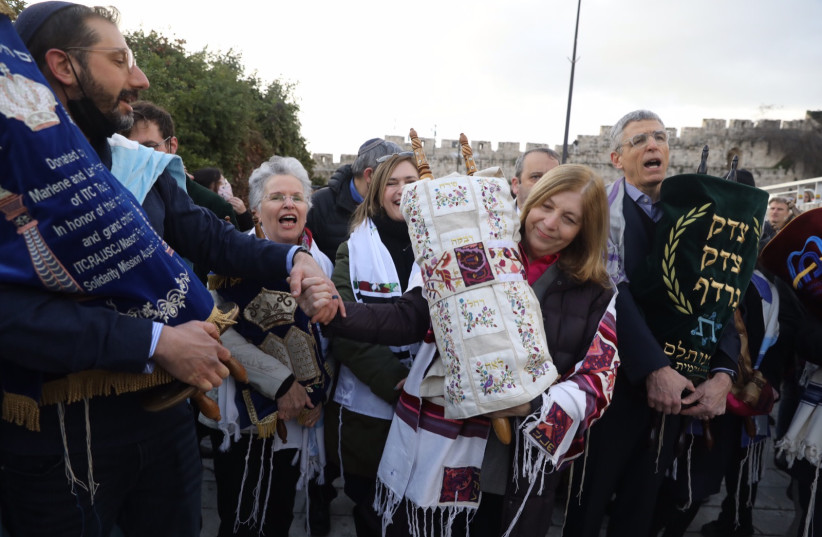  Activists in favor of Jewish egalitarian prayer at the Western Wall are seen marching with Torah scrolls through the Old City of Jerusalem on Rosh Hodesh, on March 4, 2022. (photo credit: MARC ISRAEL SELLEM)