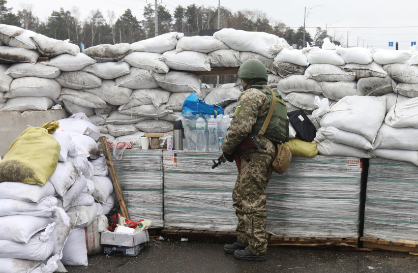  A member of the Territorial Defence Forces stands guard at a checkpoint, as Russia's invasion of Ukraine continues, in Kyiv, Ukraine March 3, 2022. (credit: Mykola Tymchenko/Reuters)