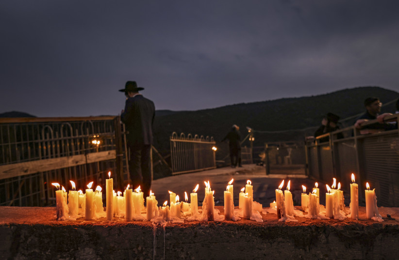  Candles are lit at the place of the disaster, at the Rashbi gravesite in Meron, Northern Israel, on March 02, 2022. (credit: DAVID COHEN/FLASH 90)