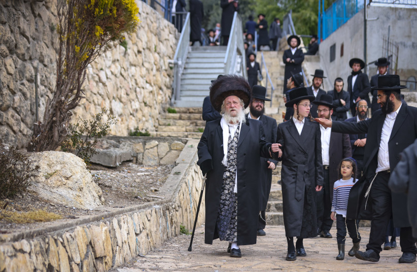  Jews visit at the Rashbi gravesite on the Eve of Rosh Chodesh in Meron, Northern Israel, on March 2, 2022. (photo credit: DAVID COHEN/FLASH 90)