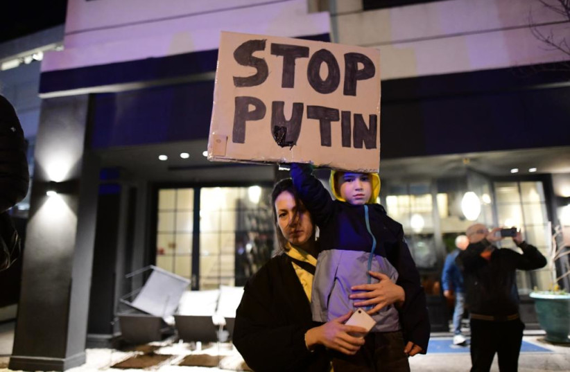  An Israeli child holding a "stop Putin" sign as Israelis protest Russia's invasion of Ukraine in front of the Russian embassy in Tel Aviv (photo credit: AVSHALOM SASSONI/MAARIV)