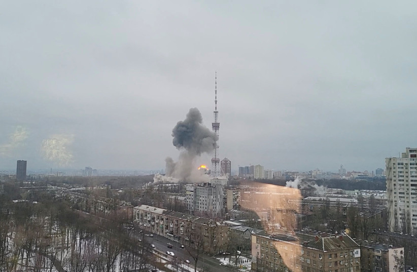 Smoke rises at a TV tower following an attack by Russian forces, amid Russia's invasion of Ukraine, in Kyiv, Ukraine March 1, 2022 in this still image taken from a video obtained from social media. (photo credit: YOUTUBE MEDPLUS/VIA REUTERS)