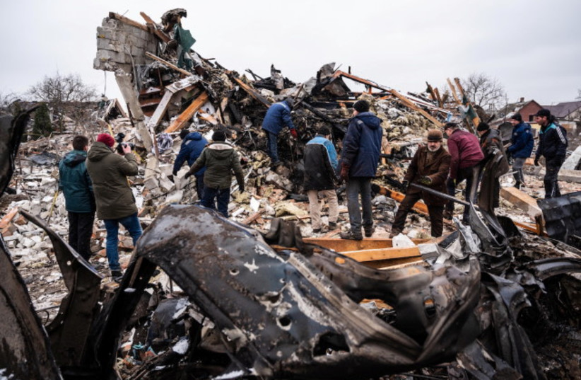  Local residents work among remains of a residential building destroyed by Russian shelling as a part of the invasion of Ukraine, in Zhytomyr, Ukraine, Mar. 2, 2022.  (photo credit: Viacheslav Ratynskyi/Reuters)