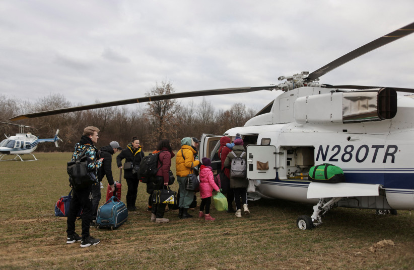  People fleeing the Russian invasion of Ukraine board a Humanitarian Aid helicopter going to Prague, Czech Republic, at a border crossing in Vysne Nemecke, Slovakia, March 5, 2022. (credit: REUTERS/LUKASZ GLOWALA)