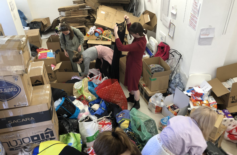 Volunteers and staff at the Ukraine Cultural Center in Tel Aviv pack donated goods for refugees, filling up the entire first floor. (credit: Lahav Harkov)