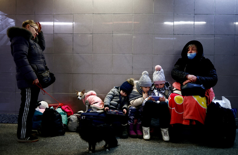  People wait at the train station after fleeing Russian invasion of Ukraine, in Przemysl, Poland, March 7, 2022. (photo credit: Yara Nardi/Reuters)