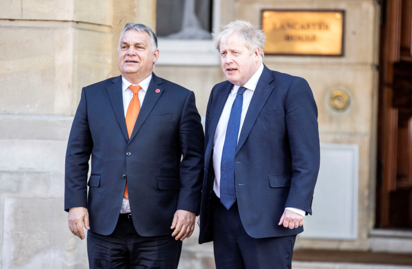 British Prime Minister Boris Johnson greets Hungarian Prime Minister Viktor Orban as he arrives at Lancaster House for the V4 + UK summit in London, Britain March 8, 2022. (credit: RICHARD POHLE/POOL VIA REUTERS)