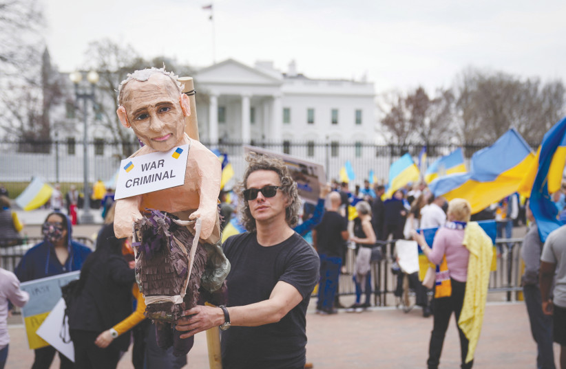  A MAN holds an effigy of Vladimir Putin during a protest in Washington earlier this week against Russia’s invasion of Ukraine.  (photo credit: SARAH SILBIGER/REUTERS)