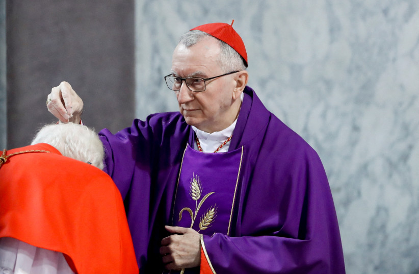  Vatican's Secretary of State Cardinal Pietro Parolin puts ashes on a cardinal's head during a mass on Ash Wednesday in Rome, Italy, March 2, 2022. (photo credit: REMO CASSILI/REUTERS)